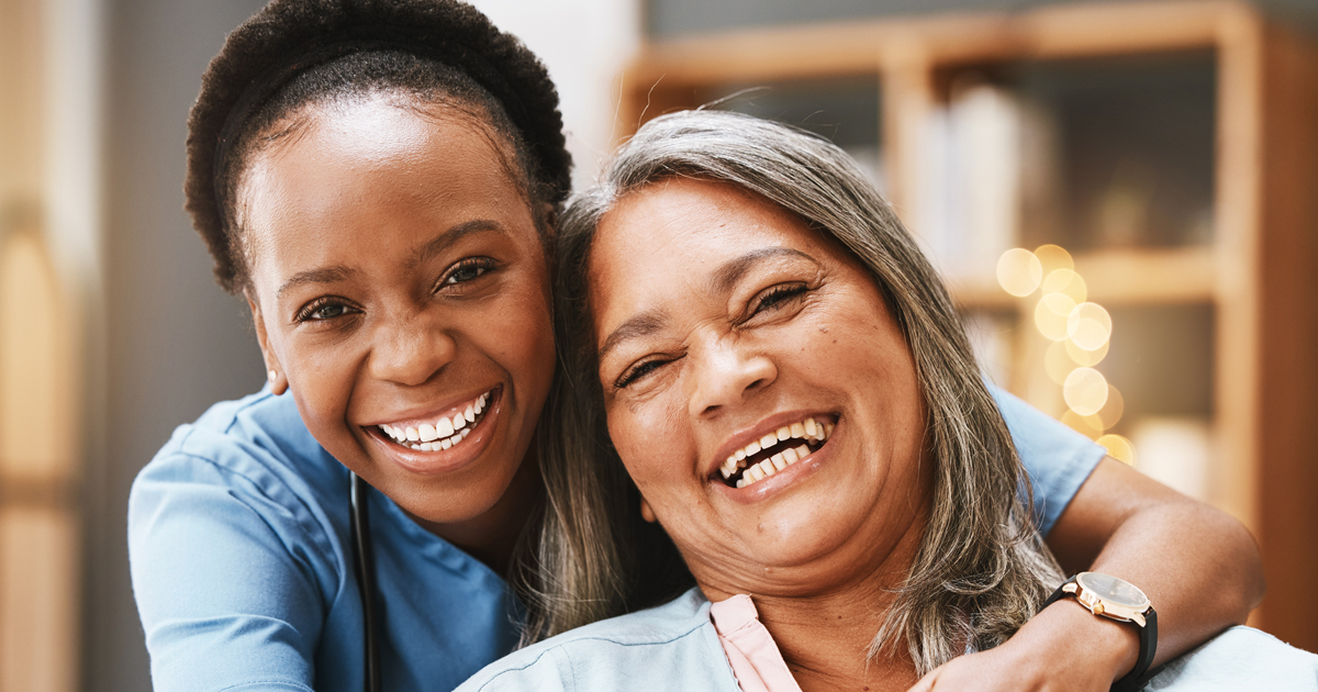 Woman of color in scrubs with woman of color resident