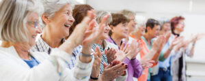 A group of senior women clapping