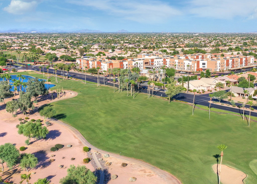 residents golfing near palm trees | Goodyear Senior Living Community
