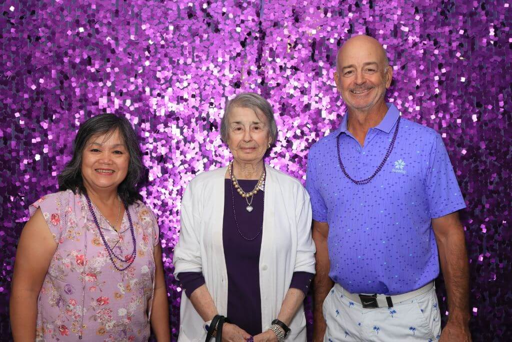 Couple posing with mom at Robson Reserve at PebbleCreek 6th anniversary photo booth