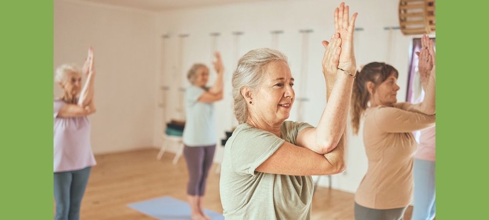 blog_july_senior_exercise_class women doing yoga in a senior exercise class