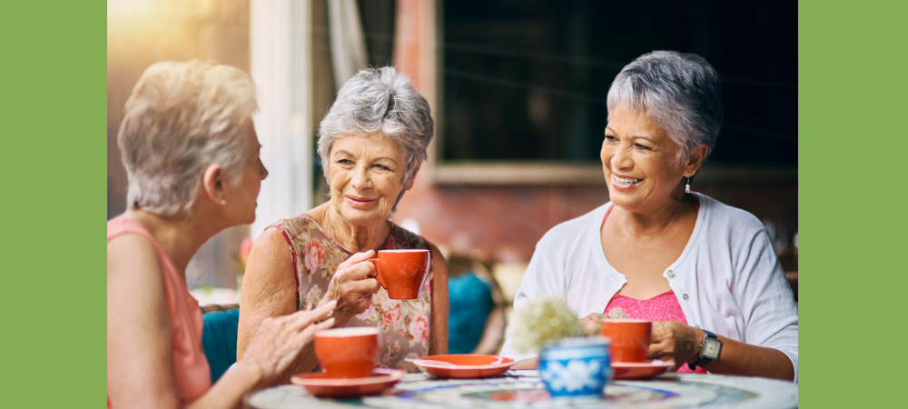 three ladies drinking coffee outside while enjoying senior summer activities