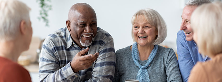 a group of senior friends laugh together