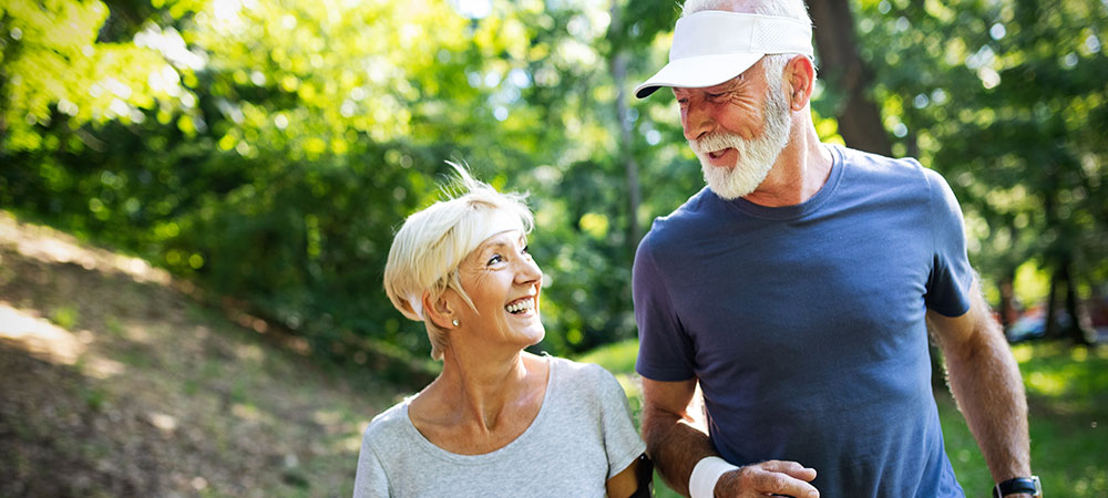 Active seniors going for a jog outdoors.